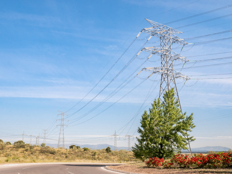 Picture of electricity pylons crossing a road.